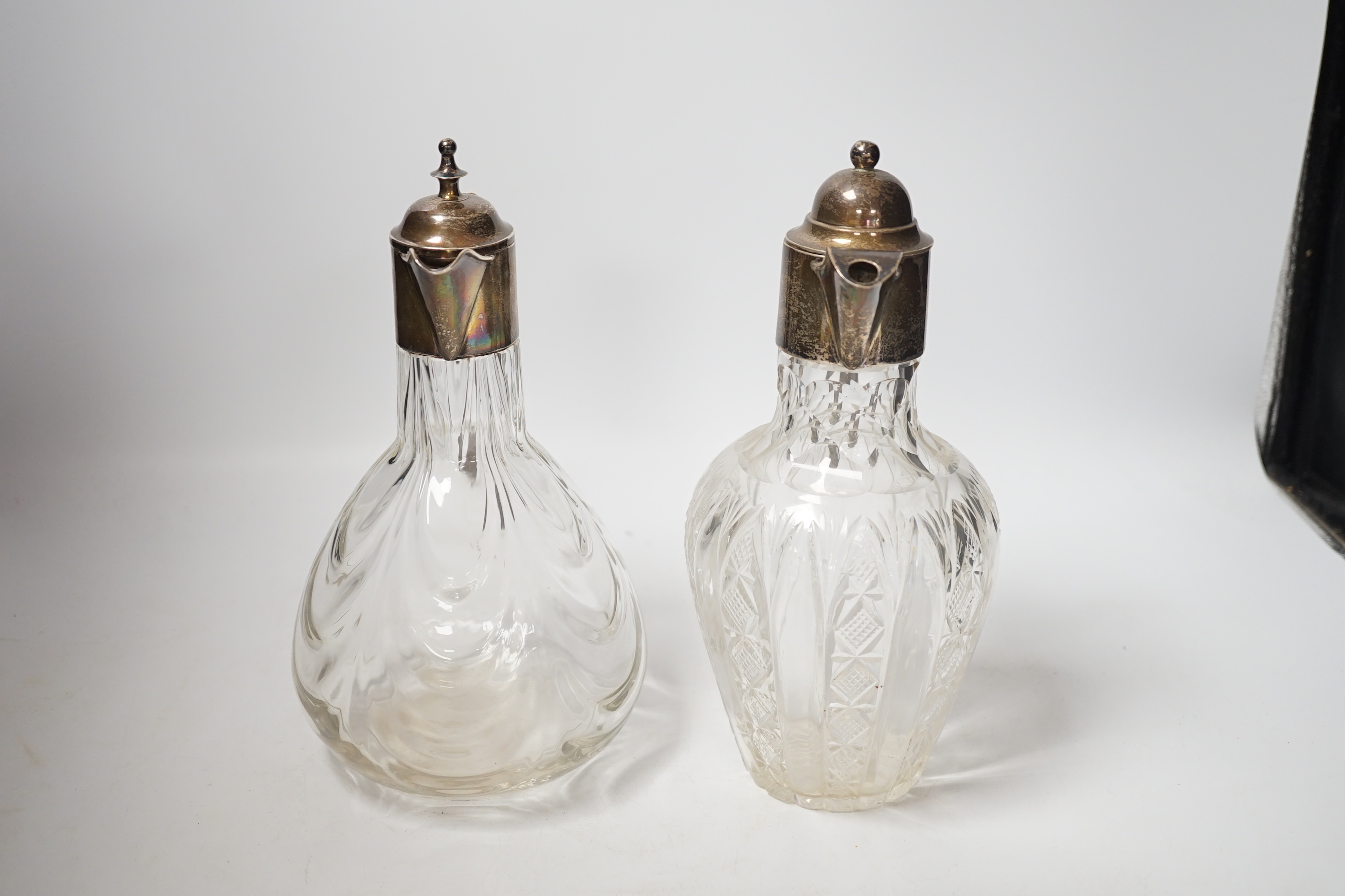 Two early 20th century silver mounted glass claret jugs, William Henry Leather, Birmingham, 1901 and William Aitken, Chester, 1901, tallest 24.2cm.